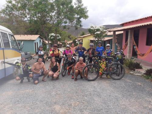 a group of people posing for a picture with their bikes at Pousada Villa Bella in Palmeiras