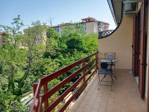 a balcony with a table and a chair on it at Piumahouse B&B in Catanzaro