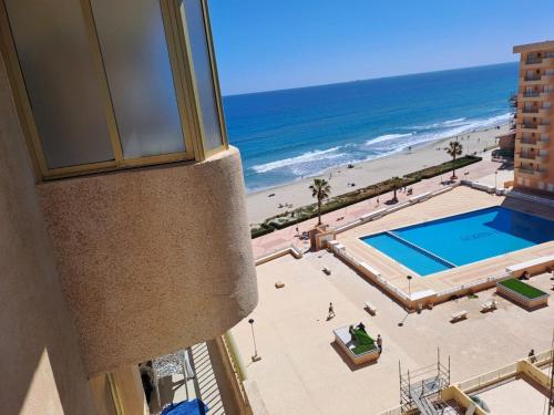 a view of a pool and the beach from a building at Apartamentos Ágata V.v. in La Manga del Mar Menor