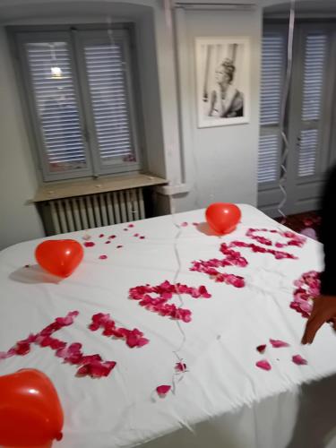 a bed with red roses and hearts on it at La casa di Cate & Adry in Envie