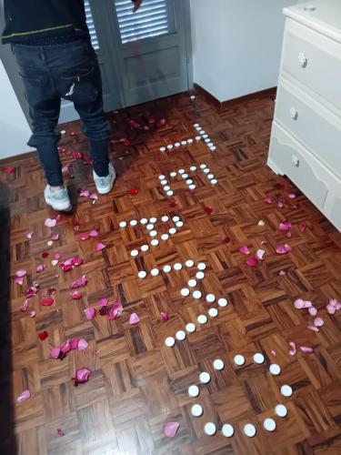 a person standing on a wooden floor with flowers on it at La casa di Cate & Adry in Envie