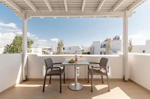 a patio with a table and chairs on a balcony at Hotel Francesca in Agios Prokopios