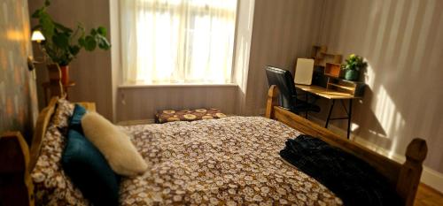 a bedroom with a bed and a window and a desk at Home away from home in Aberdeen