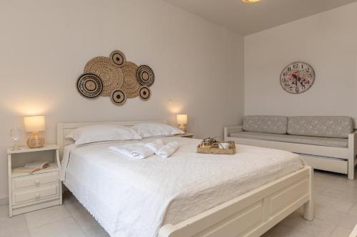 a bedroom with a bed with towels on it at Hotel Francesca in Agios Prokopios