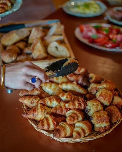 a person cutting a plate of pastries with a knife at Mas des Comtes de Provence in Tarascon