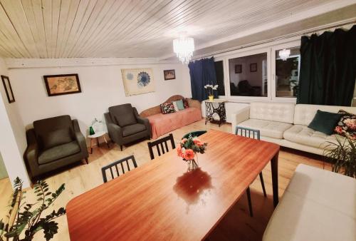 a living room with a table and a couch at Hermina Family Apartment Tatras in Ždiar