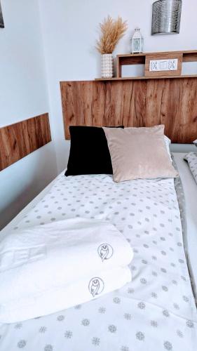 a bed with a black and white comforter at Willa Sowia nowe apartamenty nad górskim potokiem zachwycający widok na góry in Stronie Śląskie