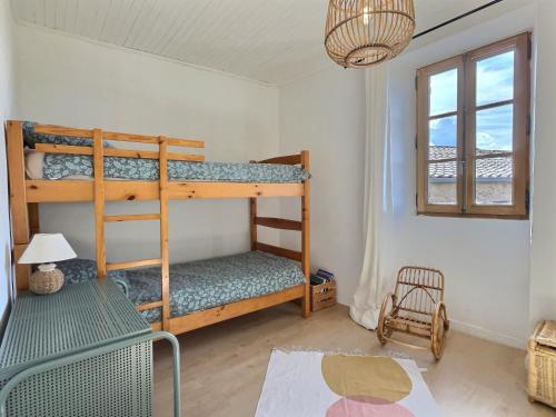 une chambre avec deux lits superposés et une fenêtre dans l'établissement Maison de la Fontaine, à Valleraugue