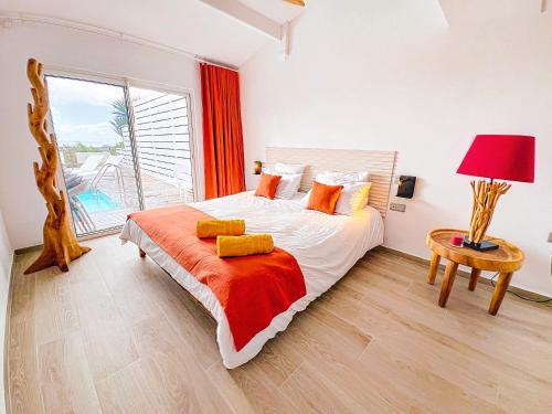 a bedroom with a bed and a large window at Villa Marguerite private pool and hot tub in Orient Bay in Orient Bay