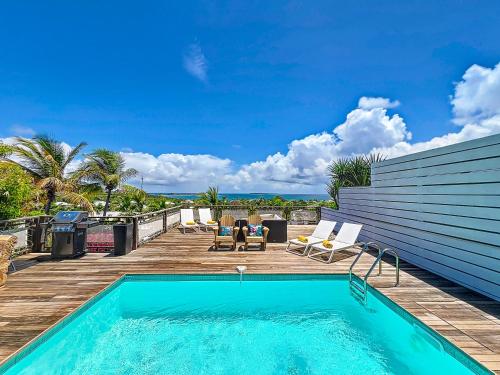 a pool on the deck of a house at Villa Marguerite private pool and hot tub in Orient Bay in Orient Bay