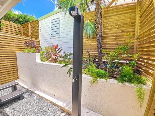 a black pole in front of a fence at Villa Marguerite private pool and hot tub in Orient Bay in Orient Bay
