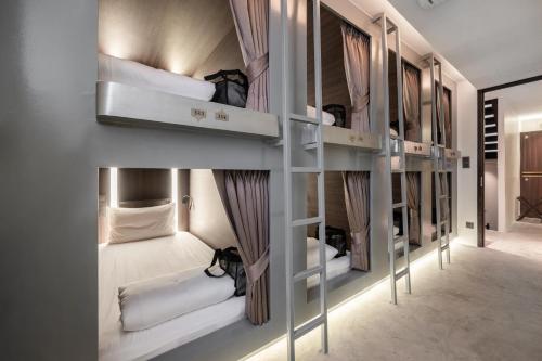 a group of bunk beds in a room at Nidhra Boutique in Bangkok