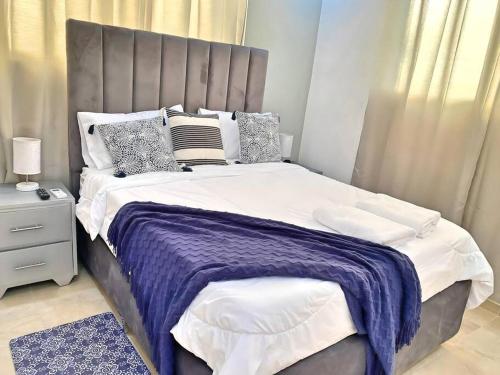 a bedroom with a large bed with a purple blanket at Apto 3 Habitaciones Zona Tranquila Con Parqueo in Concepción de La Vega