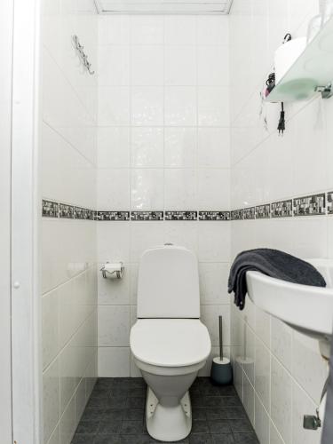 a white bathroom with a toilet and a sink at Papli 2 Accommodation in Pärnu