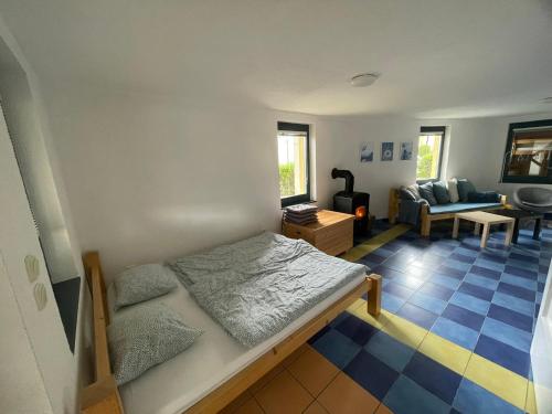 a bedroom with a bed and a living room at Ubytování Okružní 396 in Sezimovo Ústí