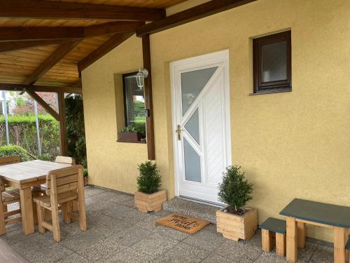 a patio with a white door and a table and chairs at Ubytování Okružní 396 in Sezimovo Ústí