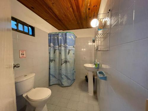 y baño con aseo y cortina de ducha. en Caribbean Queen en San Andrés