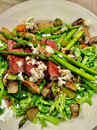 a white plate with a salad with meat and vegetables at Kaanapali's Royal Luxury Plantation Beach & Golf Retreat in Kaanapali