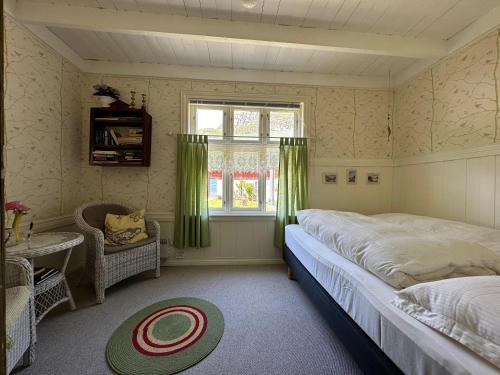 a bedroom with a large bed and a window at Hauane Bed and Breakfast in Sandnes