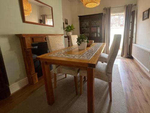 a dining room table with chairs and a mirror at Liverpool Victorian Townhouse - 3 Bedrooms in Liverpool