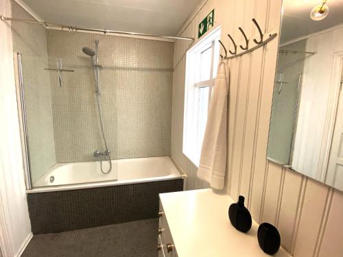 a bathroom with a shower and a tub and a sink at Day Dream Laugavegur Downtown Apartments in Reykjavík