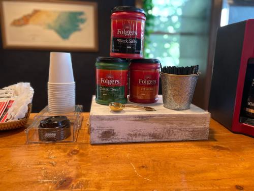 three jars of jam sitting on a wooden table at Skyline Village Inn in Spruce Pine