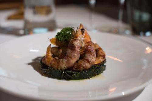 a plate of food with shrimp and broccoli on it at Borgo del Faro in Fano