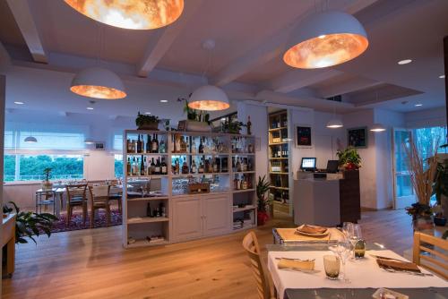 a restaurant with a bar with tables and lights at Borgo del Faro in Fano