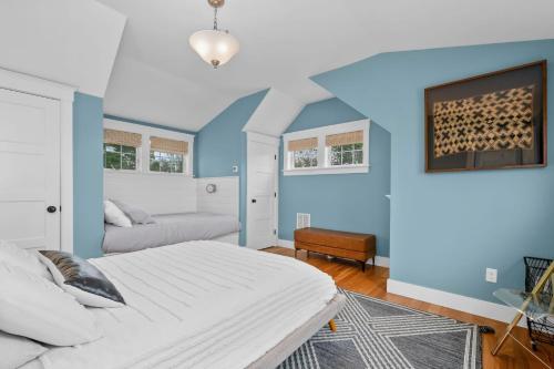 a bedroom with a white bed and blue walls at 19 State Street Sandwich - Marsh Mellow in Sandwich