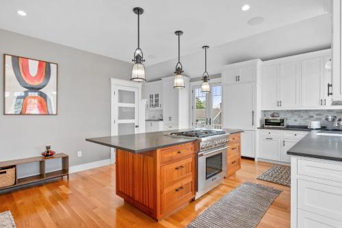 a kitchen with white cabinets and a counter top at 19 State Street Sandwich - Marsh Mellow in Sandwich