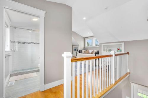 a staircase in a home with white walls and a shower at 19 State Street Sandwich - Marsh Mellow in Sandwich