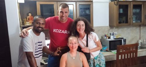a group of people posing for a picture in a kitchen at Vino Villa Tourists & Local Accommodations - 24 Hrs in Kandy
