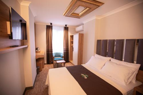 Ένα ή περισσότερα κρεβάτια σε δωμάτιο στο Hotel Milano