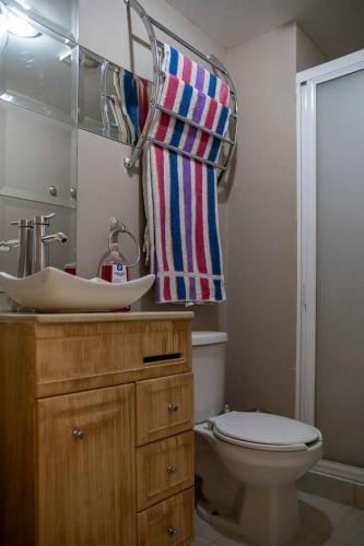 a bathroom with a sink and a toilet at New Chic Condo with Gym Access & Private Roof in Mexico City