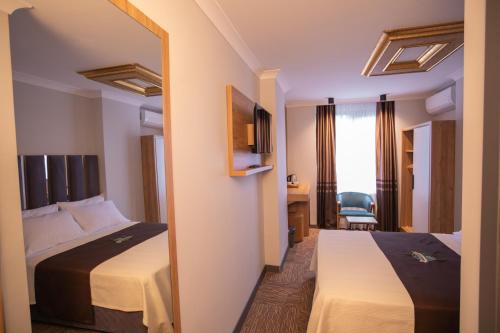 Ένα ή περισσότερα κρεβάτια σε δωμάτιο στο Hotel Milano