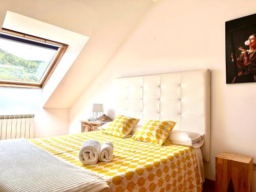 een slaapkamer met een bed met handdoeken erop bij Alianza del Castillo in Ponferrada