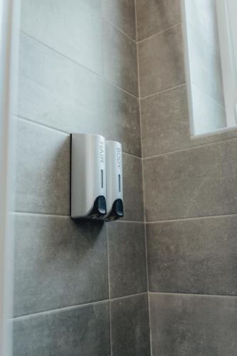 a bathroom with a soap dispenser on a tiled wall at Casa Mandarino con Parcheggio in Conversano