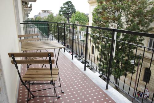 a balcony with two wooden chairs and a railing at Diana Home - Rooms and Suite in Caserta