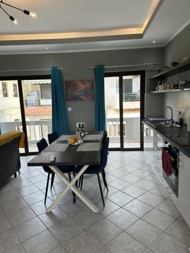a kitchen and dining room with a table and chairs at Luxury Sea View Apartment in Kolimvari in Kolymvari
