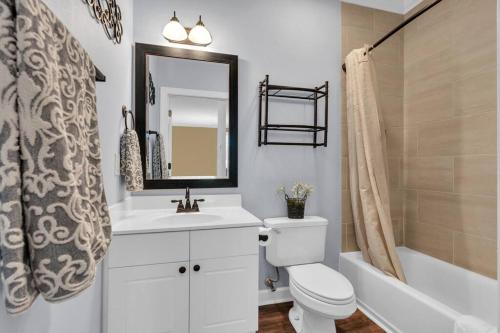 a bathroom with a sink and a toilet and a tub at Main Level End Unit Condo In North Myrtle Beach in North Myrtle Beach