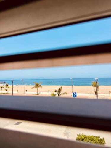 a view of the beach from a train window at Affacciati sulle Eolie Appartamenti sul Lungomare Patti Marina in Patti