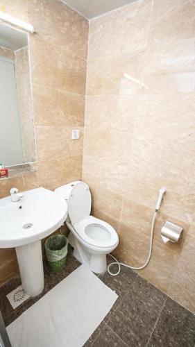 a bathroom with a toilet and a sink at Faran Hotel in Karachi