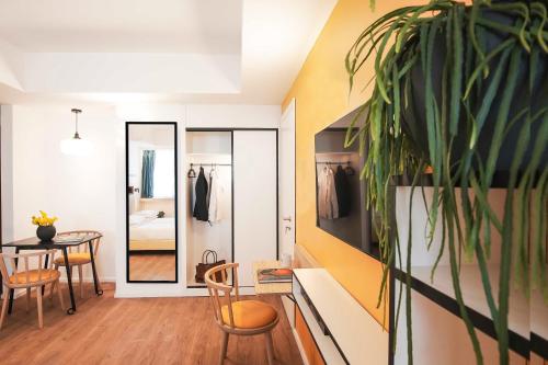 a room with a table and chairs and a mirror at Aparthotel Colombo Roma in Rome