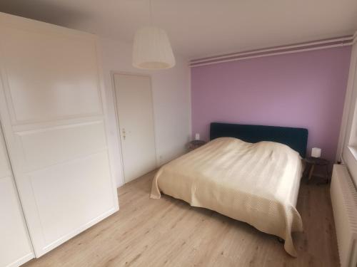 a bedroom with a bed with a white blanket at 4-Zi-WG Casa Sogno - Valle mit Kamin. Alleinlage im Rebberg! in Agarone