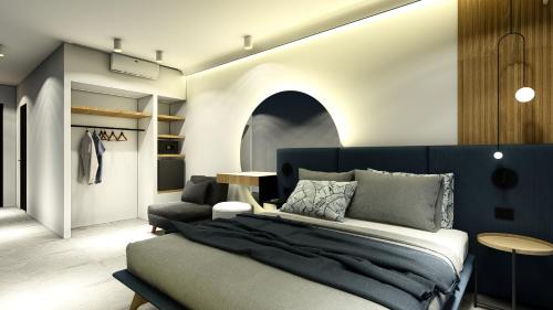 een slaapkamer met een bed en een kamer met een kast bij Seaside Marmari in Marmari