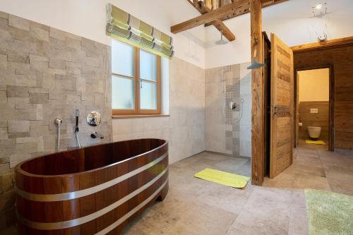 a large bathroom with a wooden tub and a shower at Bergchalet 1 in Freyung