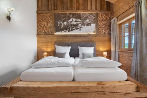 a bedroom with two beds on a wooden wall at Bergchalet 3 in Freyung