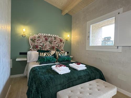 a bedroom with a bed with two towels on it at Tibo - Casal do Conde in Caldas de Reis