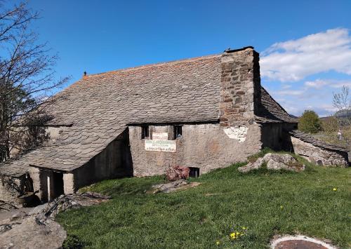 an old stone building on top of a field at Hôtel La Gravenne in Thueyts