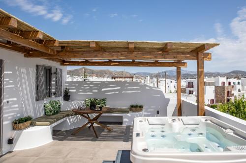 a hot tub on the roof of a house at Korali Hotel in Naxos Chora